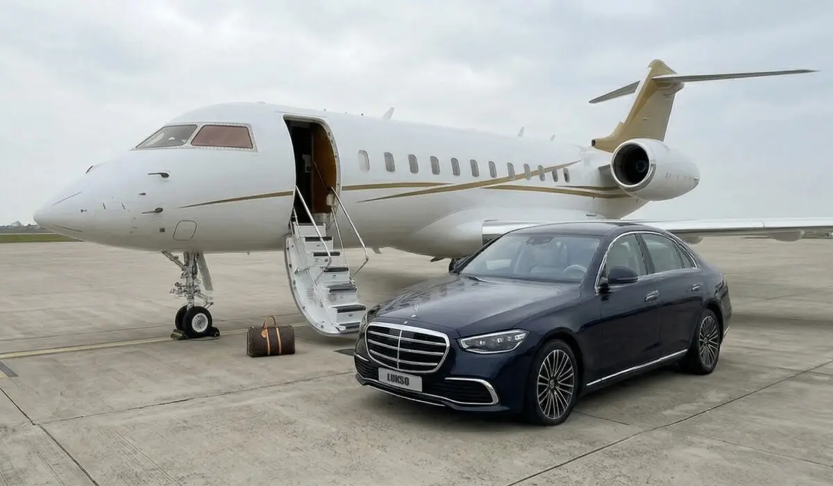 About Lukso Travel: A private jet is parked on an airport apron with its door open and a set of stairs down. Nearby, a black luxury saloon and a brown travel bag capture the elegance of the Lukso Travel experience.