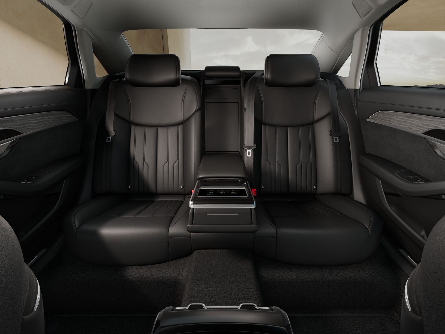 The image shows the back seat interior of a modern Audi A8L with black leather seats, a fold-down centre armrest, and minimalist design elements.
