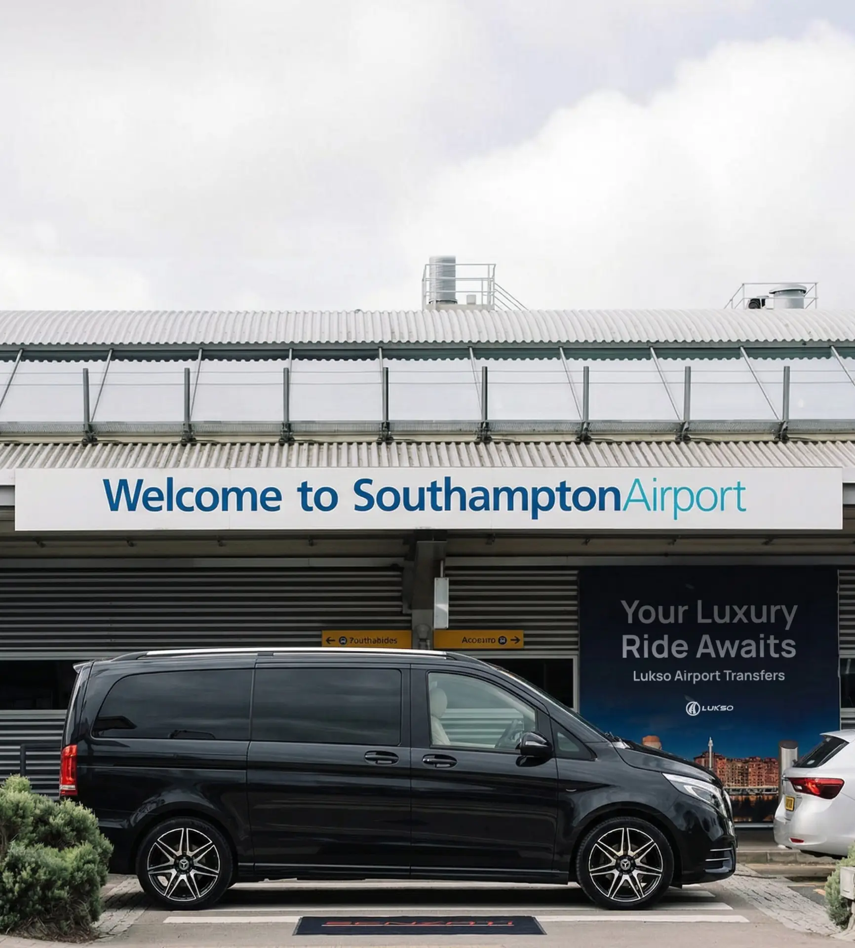 A black van parked outside Southampton Airport entrance with Welcome to Southampton Airport sign visible